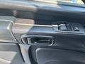 Close-up of the door handle and window controls of a 2020 Hino 338 truck interior