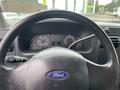 Interior view of a 2005 Ford F-350 SD dashboard with a steering wheel and instrument panel displaying speed and fuel gauges