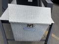 Metal tool chest with a diamond plate design featuring a lock on the front and a hydraulic lift lid