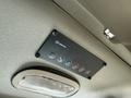 Control panel featuring buttons for air conditioning lights and other functions mounted on the ceiling of a vehicle