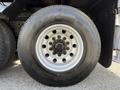 Close-up of a wheel on a 2008 Kenworth T370 featuring an aluminum rim and a large tire with visible tread and lug nuts in the center