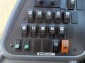 Control panel of a 2009 International 3000 CE school bus featuring various switches and buttons for lights and heating functions