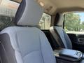 Two front seats of a 2020 Ram 2500 with gray fabric upholstery and a center console between them