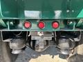 Undercarriage of a 2015 Peterbilt 337 showing red circular lights and air suspension components with large black tires