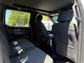 Interior view of a 2018 Ford F-150 showing the rear seating area with black fabric upholstery and a center console