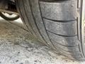 Close-up of a worn tire from a 2004 BMW 6-Series showing tread patterns and dirt accumulation