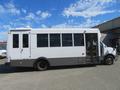 A white 2020 Chevrolet Express bus with large windows and a side door displaying a spacious interior designed for passenger transport