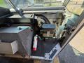 Interior view of a 2012 Ford Econoline showcasing the dashboard area including controls battery and a fire extinguisher