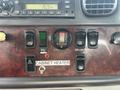 Interior dashboard controls of a 2010 Freightliner M2 106 including various switches and gauges for heating, locking, and engine functions