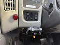 The dashboard of a 2011 International 4300 featuring buttons for lights and panel controls along with an ignition switch and a mounted device holder