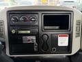 Dashboard of a 2011 International 4300 featuring climate controls a radio and a warning label