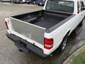 A white 2011 Ford Ranger with an aluminum truck bed and black rubber liner showing the rear view and part of the tailgate