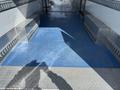 The interior of a 2016 Mercedes-Benz Sprinter with a blue floor and metal side walls featuring diamond plate patterns