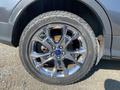 A close-up view of a silver alloy wheel from a 2016 Ford Escape featuring multi-spoke design and a Falken tire