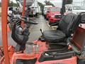 A 2015 Kubota F3990 agricultural tractor featuring a black driver's seat and controls including a steering wheel and levers