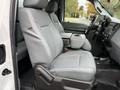 A 2015 Ford F-350 SD with gray leather front seats featuring a center console and adjustable seat controls.