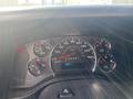 Dashboard of a 2011 Chevrolet Express displaying speedometer fuel gauge and various indicator lights with a mileage reading of 0497 K