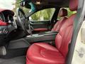 A 2016 Maserati Ghibli featuring red leather seats and a sleek interior design with modern controls and accents