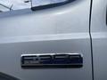 A silver 2007 Ford F-350 Super Duty with a chrome badge displaying the model name F-350