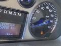Close-up of the dashboard of a 2007 Cadillac Escalade showing the speedometer and odometer displaying 53895 km
