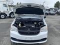 A 2014 RAM Cargo Van with the hood raised showcasing the engine compartment and various components visible inside