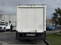 A white 2008 International CityStar truck with a large cargo box and a diamond hazard placard on the rear