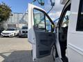 A 2018 Ford Transit-350 van with the driver's side door open showcasing the interior and dashboard