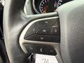 Close-up of the steering wheel controls of a 2019 Jeep Grand Cherokee featuring buttons for navigation phone calls and settings