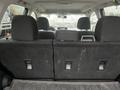 Interior view of a 2016 Subaru Forester showing the rear seats folded down with a black fabric lining and seat latches visible