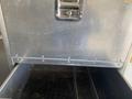 A silver metal drawer with a handle and three compartments on a 2008 Wells Industries Inc EW1422 equipment unit