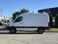 A white 2024 Mercedes-Benz Sprinter 2500 parked with its side view visible showcasing a smooth design and high roofline