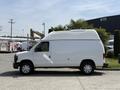 A white 2008 Ford Econoline van with a high roof and side windows, parked and facing to the left
