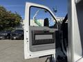 A white 2017 Ford F-650 Super Duty truck door is open showcasing a gray interior panel and handle