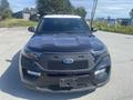 A 2020 Ford Explorer in black with a sleek design features a prominent front grille and distinctive headlights