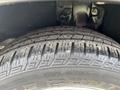 Close-up of a tire from a 2014 Honda CR-V showing tread pattern and slight wear on the rubber surface