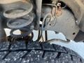 Close-up of the suspension system of a 2016 Ford F-250 SD showcasing springs and brake lines with a tire partially visible in the foreground