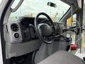 Interior view of a 2014 Ford Econoline showcasing the dashboard steering wheel and controls