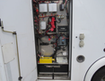 The image shows the interior of a service compartment from a 2011 Chevrolet Express featuring various electrical components and wiring