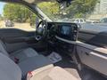 Interior of a 2023 Ford F-350 SD showing gray seats a dashboard with a large screen and control panel