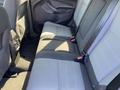 Rear seating area of a 2016 Ford Escape with two fabric-covered seats featuring seat belts and a dark interior