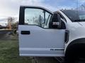 A white 2017 Ford F-550 with an open door displaying the interior and side mirror, featuring '6.7 Power Stroke' emblem on the lower door panel