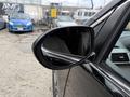A 2014 Honda Odyssey with a focus on the driver's side mirror, showcasing its sleek design and reflective surface