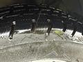 A close-up view of a wet tire tread of a 2023 Ford Transit showing grooves and texture designed for traction