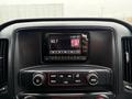 Dashboard display of a 2015 GMC Sierra 1500 showing radio station 93.7 with various control buttons beneath the screen