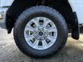 Close-up view of a silver alloy wheel with a black rugged tire on a 2020 Ford F-350