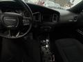 Interior view of a 2017 Dodge Charger showing the steering wheel dashboard and front seats with a focus on controls and features