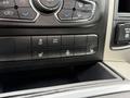 The control panel of a 2018 RAM 1500 featuring buttons for air conditioning, tow/haul mode, heated seats, and other vehicle functions