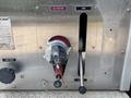 A silver control panel with labeled switches and gauges for a 1999 Freightliner FL80 including a suction gauge and a lever for opening and closing valves