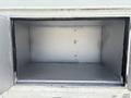 An empty metal storage compartment of a 2011 Workhorse W62 with a smooth gray interior and no visible items inside