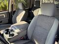 Interior of a 2014 RAM 5500 featuring gray upholstered seats with a center console and cup holders